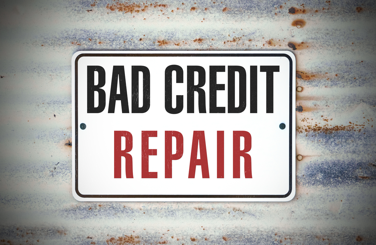 A sign posted to a wall that says bad credit repair