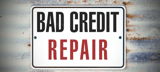 A sign posted to a wall that says bad credit repair