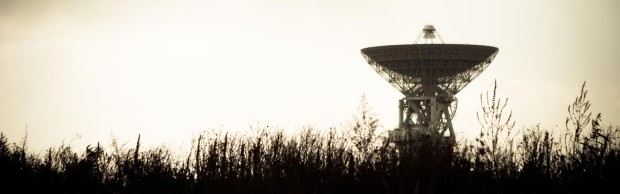 A large satellite dish standing in a field