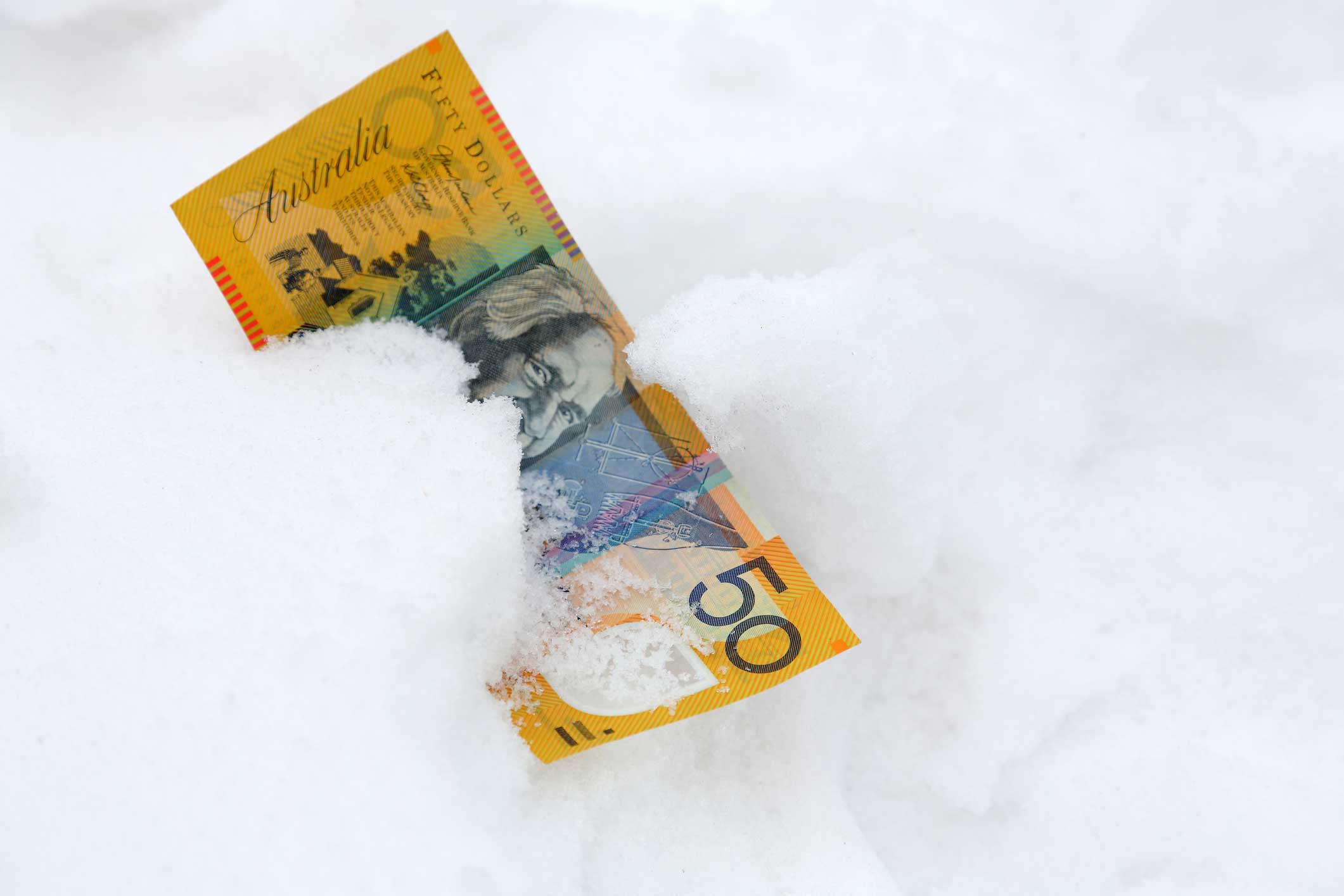 A fifty dollar note lying in snow